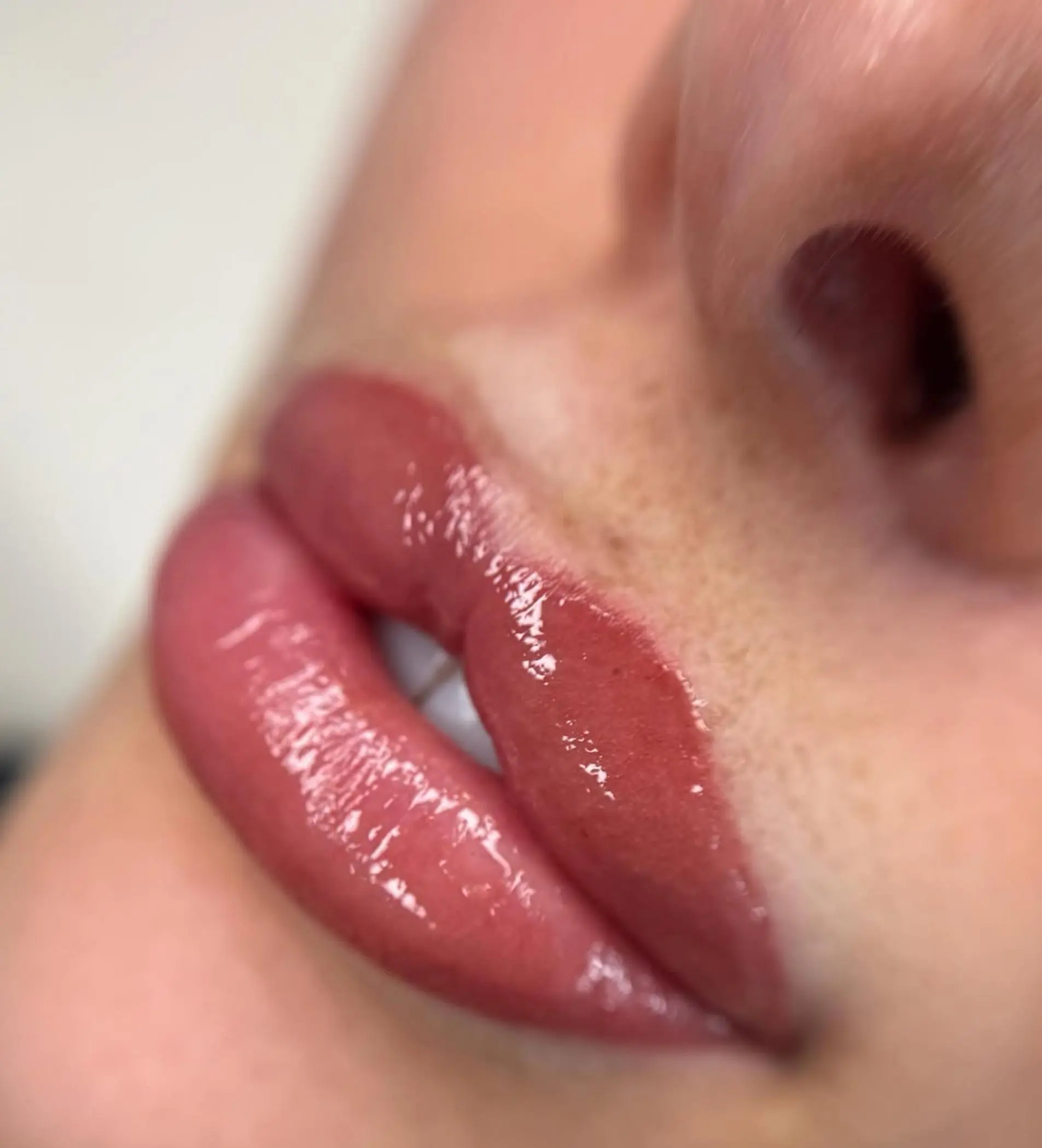 technician applying lip tattoo