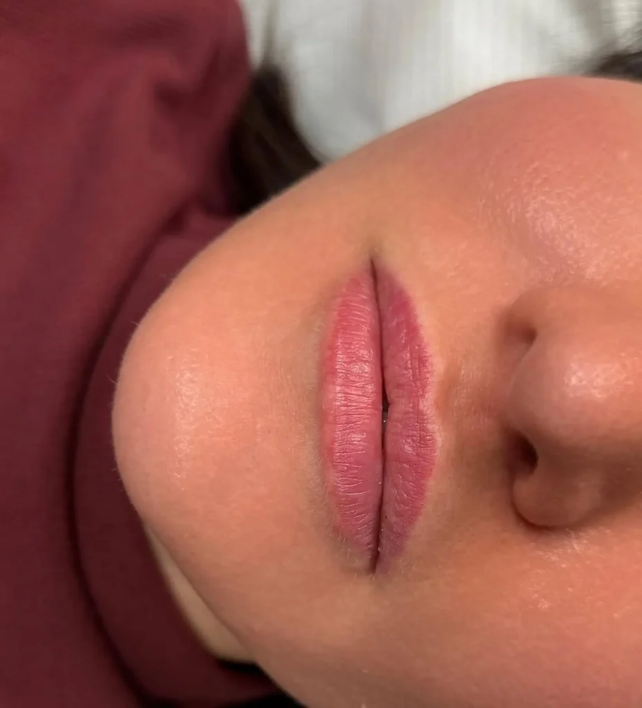 technician applying lip blush tattoo